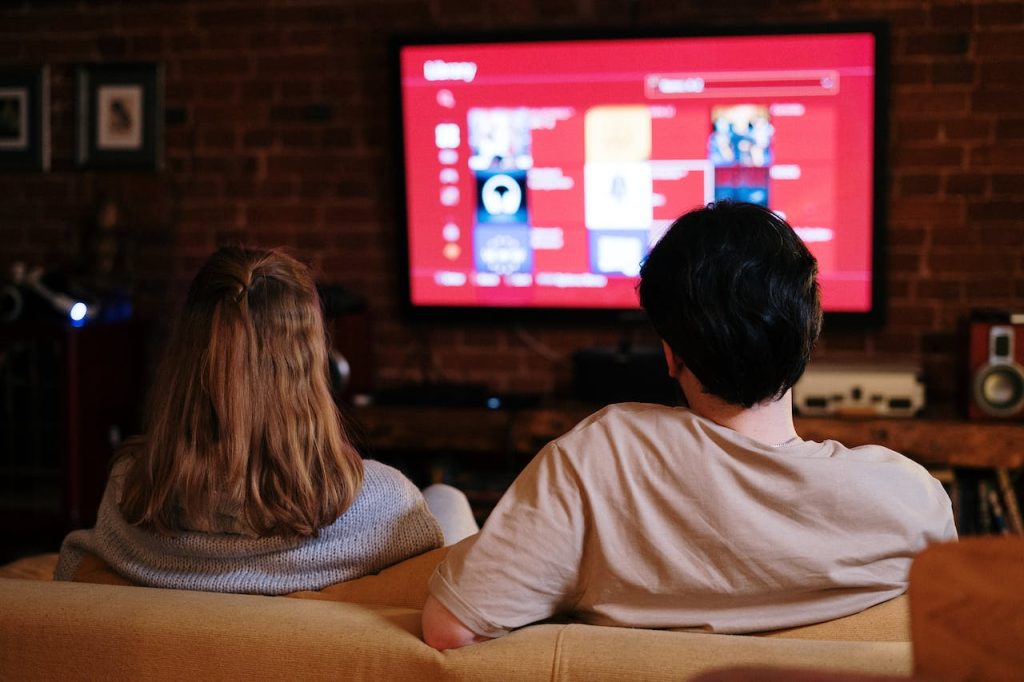 Best Smart TV Review Guide 2023 | Top Picks 11 Couple sitting on couch watching Smart TV